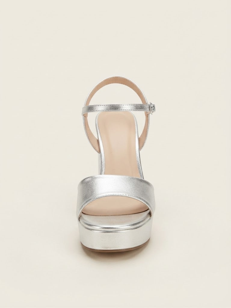 A single metallic silver high-heeled sandal with an ankle strap and platform sole, shown from a top-down view on a light beige background.