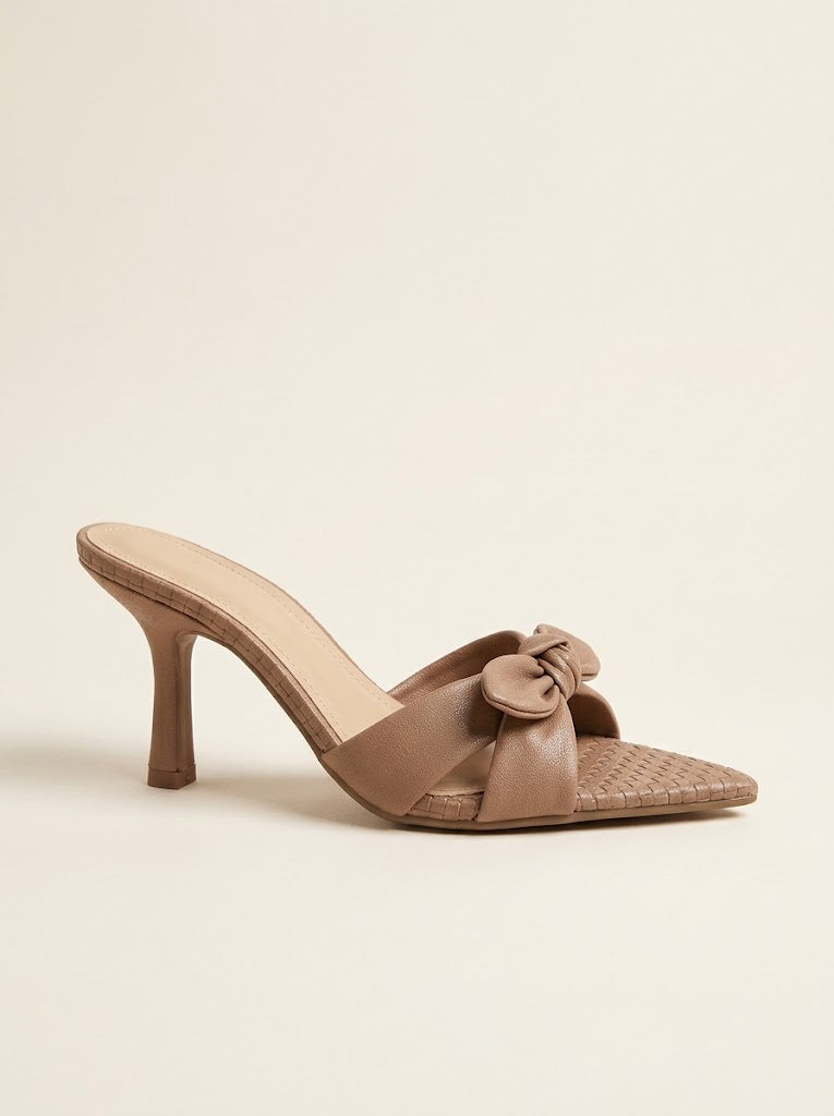 A single taupe-brown heeled mule sandal with a woven toe strap and a matching fabric bow detail, shown from a side profile on a light beige background.