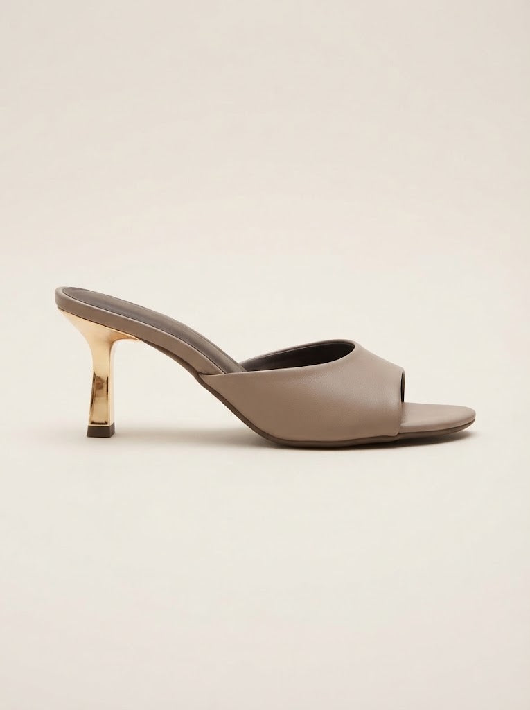 A single taupe leather mule sandal with a metallic gold high heel, shown in a side profile on a light beige background.